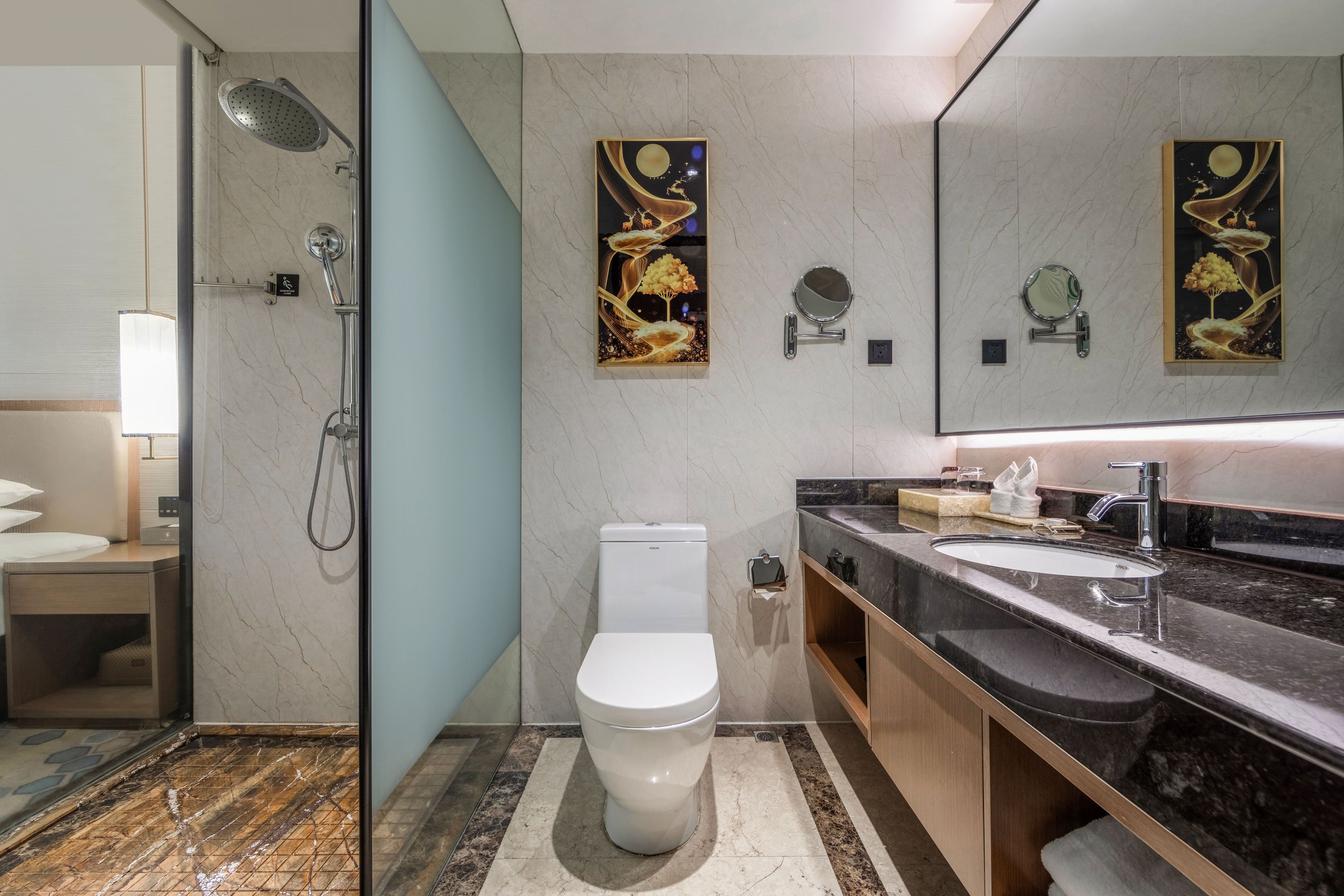 A modern bathroom with a shower, toilet, and sink.