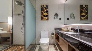 A modern bathroom with a shower, toilet, and sink.