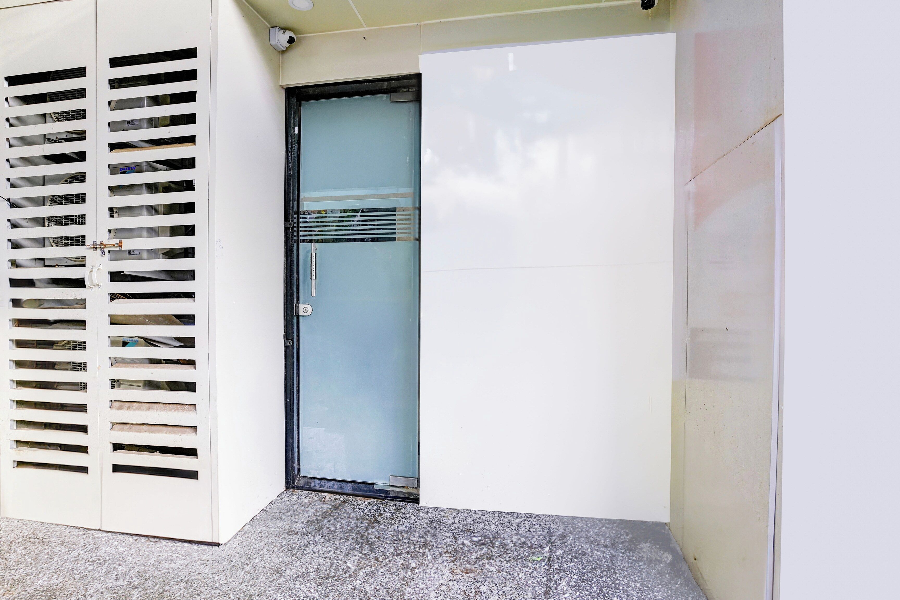A door with a metal grill, a glass panel, and a handle.