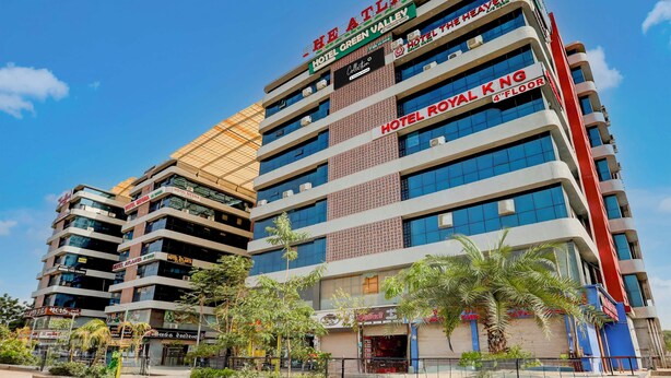 A multi-story hotel with various brands including ATLANTA, GREEN VALLEY, and ROYAL KNG. - Collection Ransan Circle Nana Chiloda (Gandhinagar)
