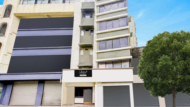 A multi-story building with a flat facade, large windows, and a sign indicating a company service. - O Ulhasnagar Formerly Hotel Derby (Mumbai)