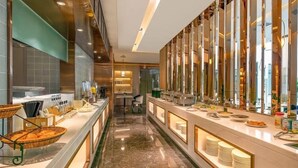 A hotel kitchen with a long counter, buffet setup, and a central island. - Atour Hotel (Lanzhou)