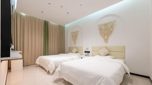A hotel room with two beds, a desk, and a large window with curtains. - 7 Days Inn (Jiuquan)