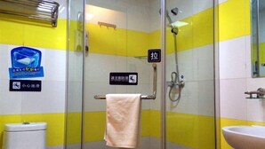 A bathroom with a glass shower enclosure, a white sink, and a toilet. There is a towel hanging on a rack and a sign indicating a hand dryer. - 7 Days Inn (Jiuquan)
