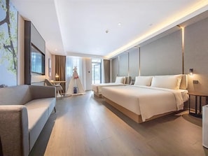 A modern hotel room with a large bed, a sofa, a desk, and a tent-like decoration. - Beijing Road Atour Hotel (Linyi)