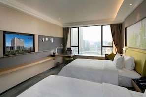 A hotel room with two beds, a desk, a chair, a TV, and a large window with a city view. - Hampton by Hilton (Guangzhou)