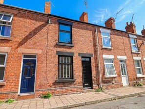 A row of terraced houses with brick facades, numbered doors, and small windows. - 9 North Street (Chester)