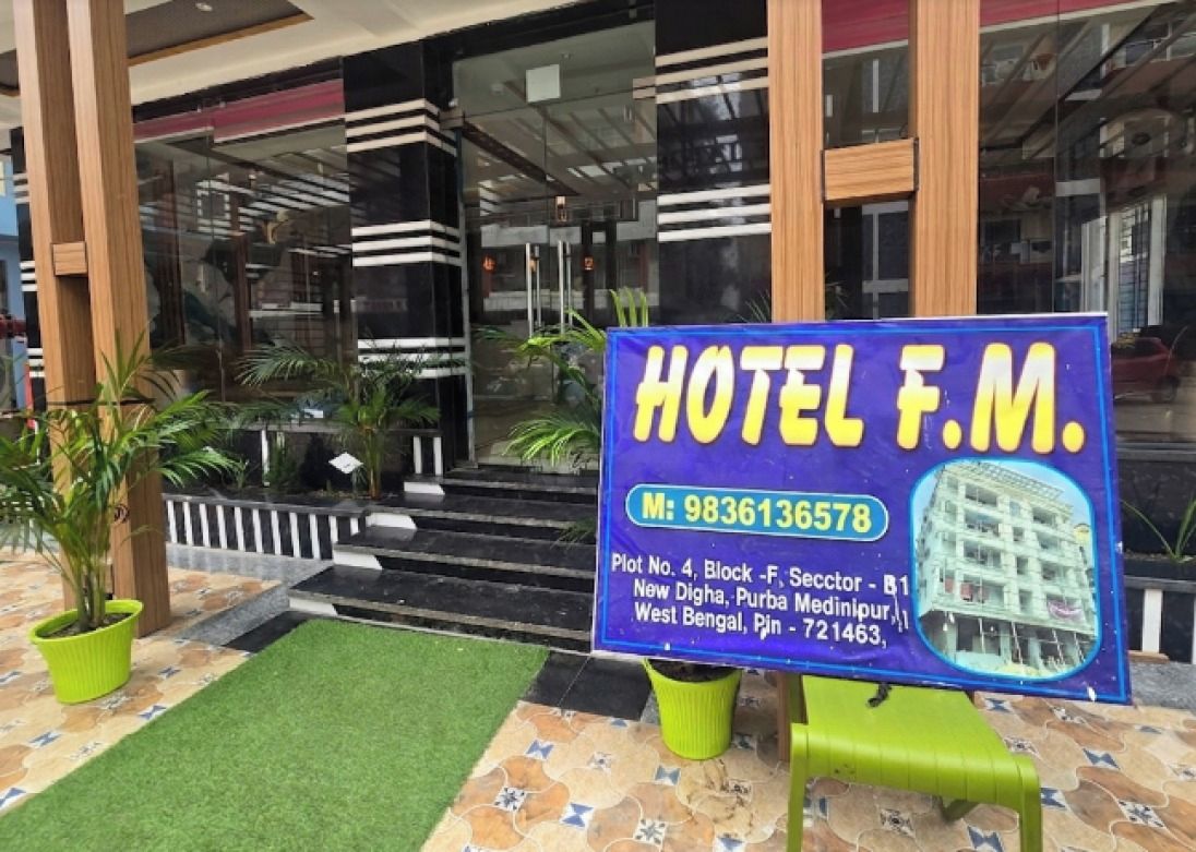 A hotel sign with the name 'HOTEL F.M.' and contact information.
