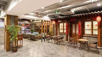 A traditional-style interior with wooden furniture, tiled flooring, and decorative lanterns.