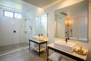 A modern bathroom with two sinks, a glass-enclosed shower, and a large mirror. - Ciela, Lusaka, a Tribute Portfolio Resort and Spa (Lusaka)