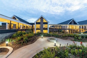 A modern building with a central courtyard, surrounded by lush greenery and pathways. - Ciela, Lusaka, a Tribute Portfolio Resort and Spa (Lusaka)
