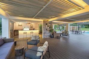 An outdoor bar area with seating and a poolside view. - Ciela, Lusaka, a Tribute Portfolio Resort and Spa (Lusaka)