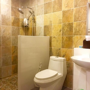 Un baño con ducha, inodoro y lavamanos.
