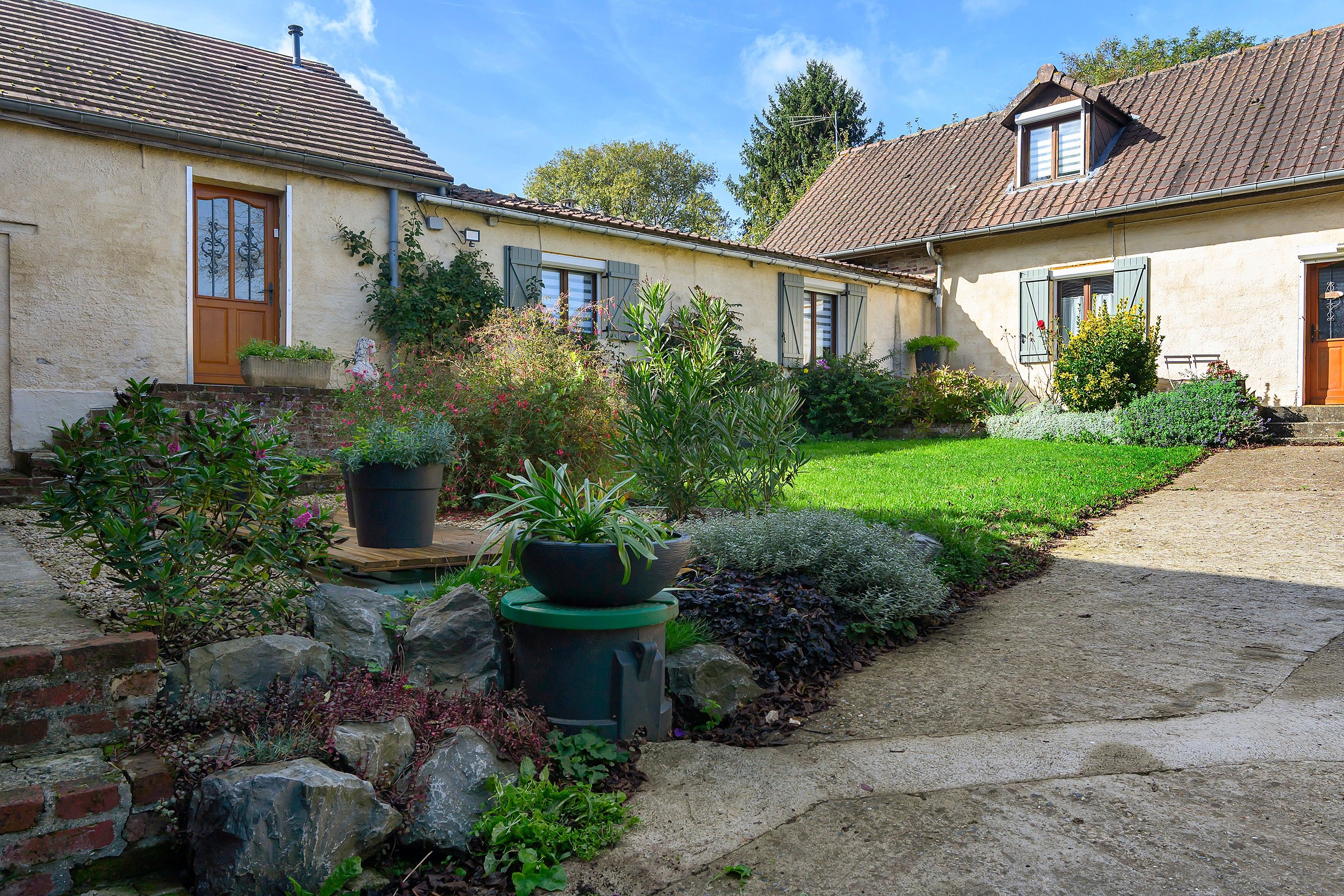 A two-story house with a garden in front.