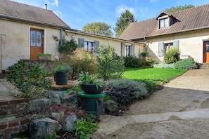A two-story house with a garden in front.