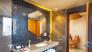 A modern bathroom with a large mirror, two sinks, and a vanity with toiletries. - Inde Signature Jaipur (Jaipur)