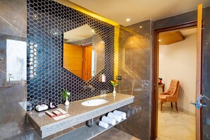 A modern bathroom with a large mirror, two sinks, and a vanity with toiletries. - Inde Signature Jaipur (Jaipur)
