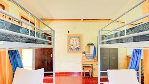A room with bunk beds, a desk, and a chair. There is a picture on the wall and a window with curtains. - Ubud Asri by Zuzu (Ubud)