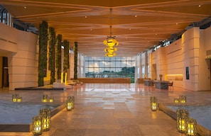 A spacious lobby with a high ceiling, large windows, and a central seating area. - Chengdu Expo Waterfall Hotel - Mgallery Collection (Chengdu)