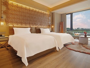 A hotel room with two beds, a large window, and a decorative wall panel. - Chengdu Expo Waterfall Hotel - Mgallery Collection (Chengdu)