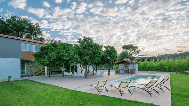 A backyard with a swimming pool, lounge chairs, and a small building. - Quinta da Teimosa by Portugal Active (Viana do Castelo)