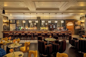 A bar area with multiple seating arrangements, a bar counter, and hanging light fixtures. - Hotel La Compania In The Unbound Collection By Hyatt (Panama City)