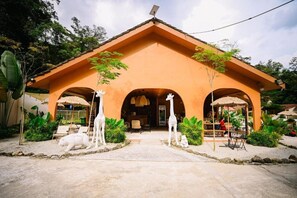 A building with a sloped roof and a central entrance flanked by two arches. - Lilla Rainforest Retreats (Hulu Langat)