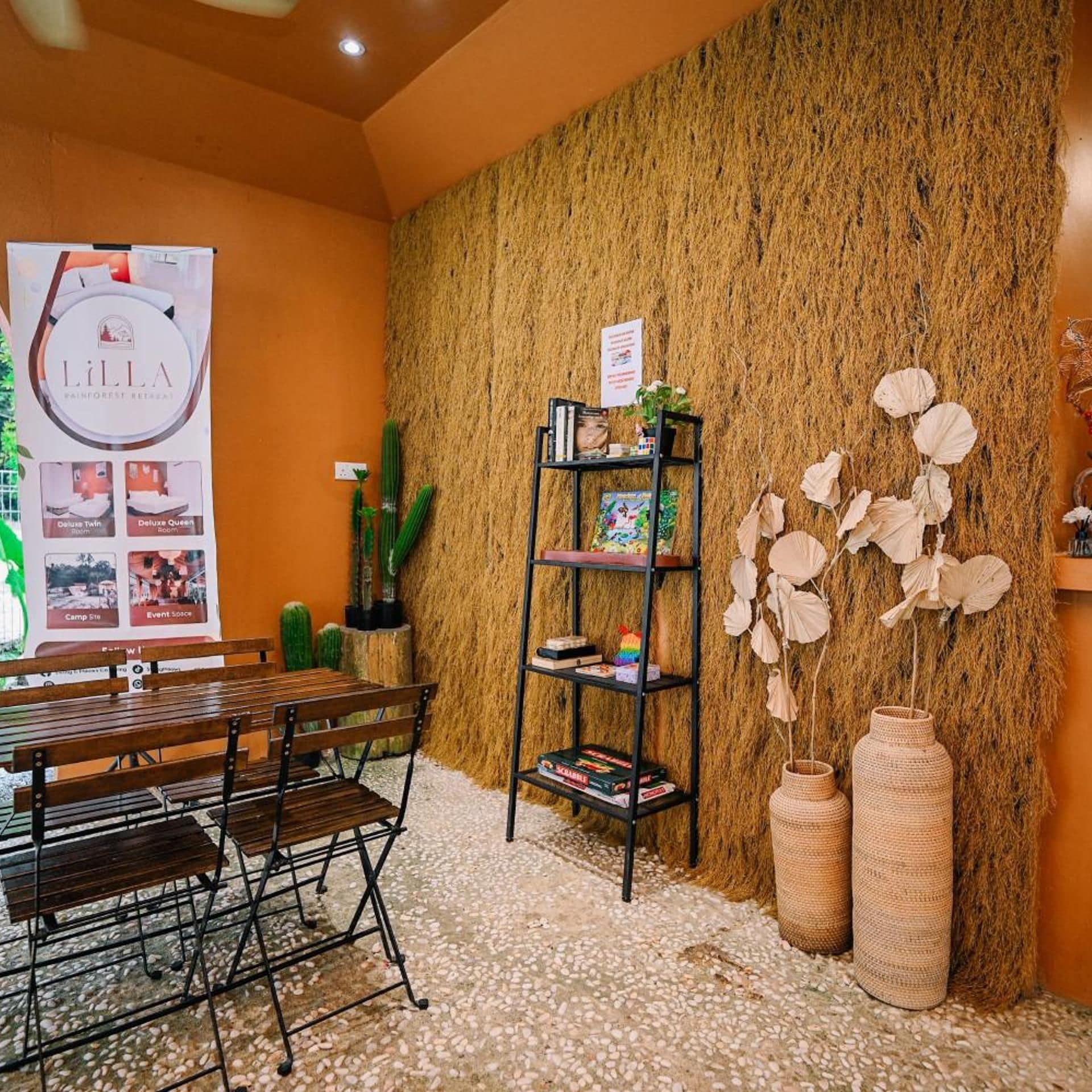 A room with a wooden bench, a bookshelf, and a wall covered in textured material.