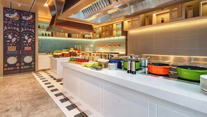 Una cocina moderna con una isla central, electrodomésticos de acero inoxidable y una variedad de utensilios y recipientes de cocina.