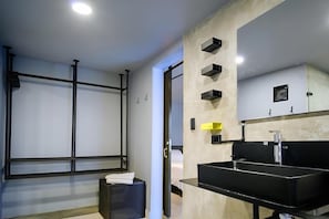 A modern bathroom with a black sink, a large mirror, and a towel rack. - Hostel Joy Cll 85 (Bogotá)
