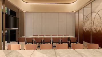 A conference room with a long table and chairs, a bookshelf, and a decorative wall.