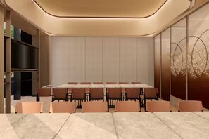 A conference room with a long table and chairs, a bookshelf, and a decorative wall. - Hilton Garden Inn Tianjin Jinnan (Tianjin)
