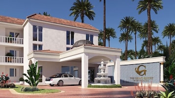 A multi-story hotel with a white facade, a covered entrance, and a fountain.