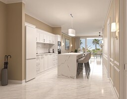 A modern kitchen with marble countertops, a central island, and bar stools.