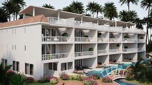 Un hotel de varios pisos con balcones, piscina y jardines tropicales.