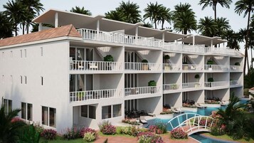 Un hotel de varios pisos con balcones, piscina y jardines tropicales.