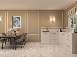 Una cocina moderna con encimera de mármol, armarios blancos y un comedor con mesa preparada para cuatro.
