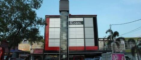 A building with a prominent 'GLOBAL' sign, a large vertical structure, and a red and white facade.