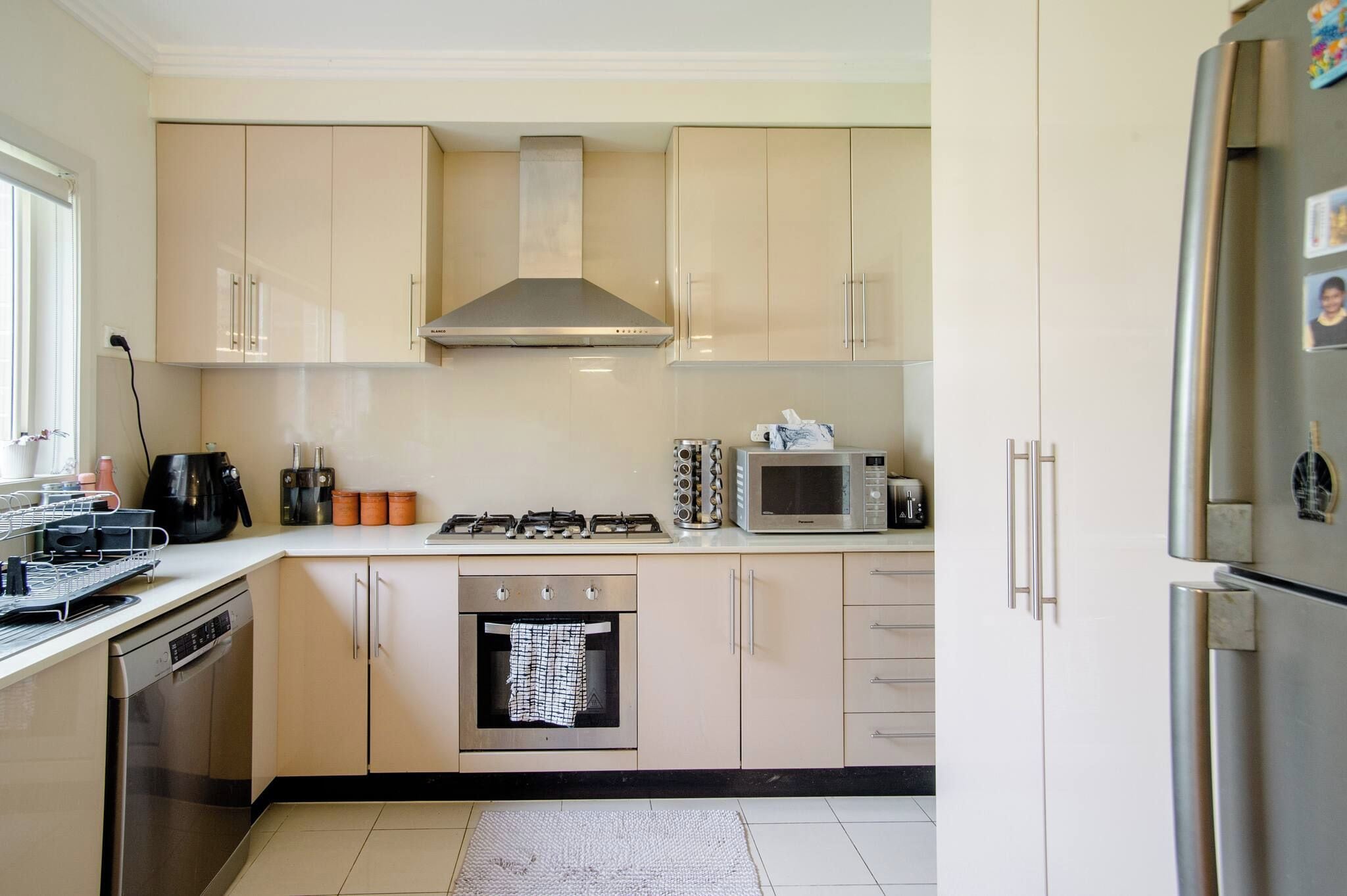 A kitchen with a stove, oven, microwave, and refrigerator.