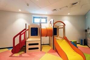 A children's play area with a slide, climbing structures, and a window. - Vanilla Homes Modern 1BR in Reem Island (Abu Dhabi)