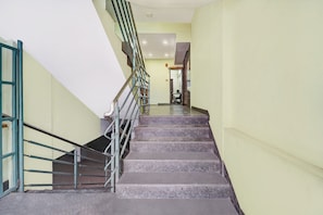 A staircase with metal railings leading to a landing.