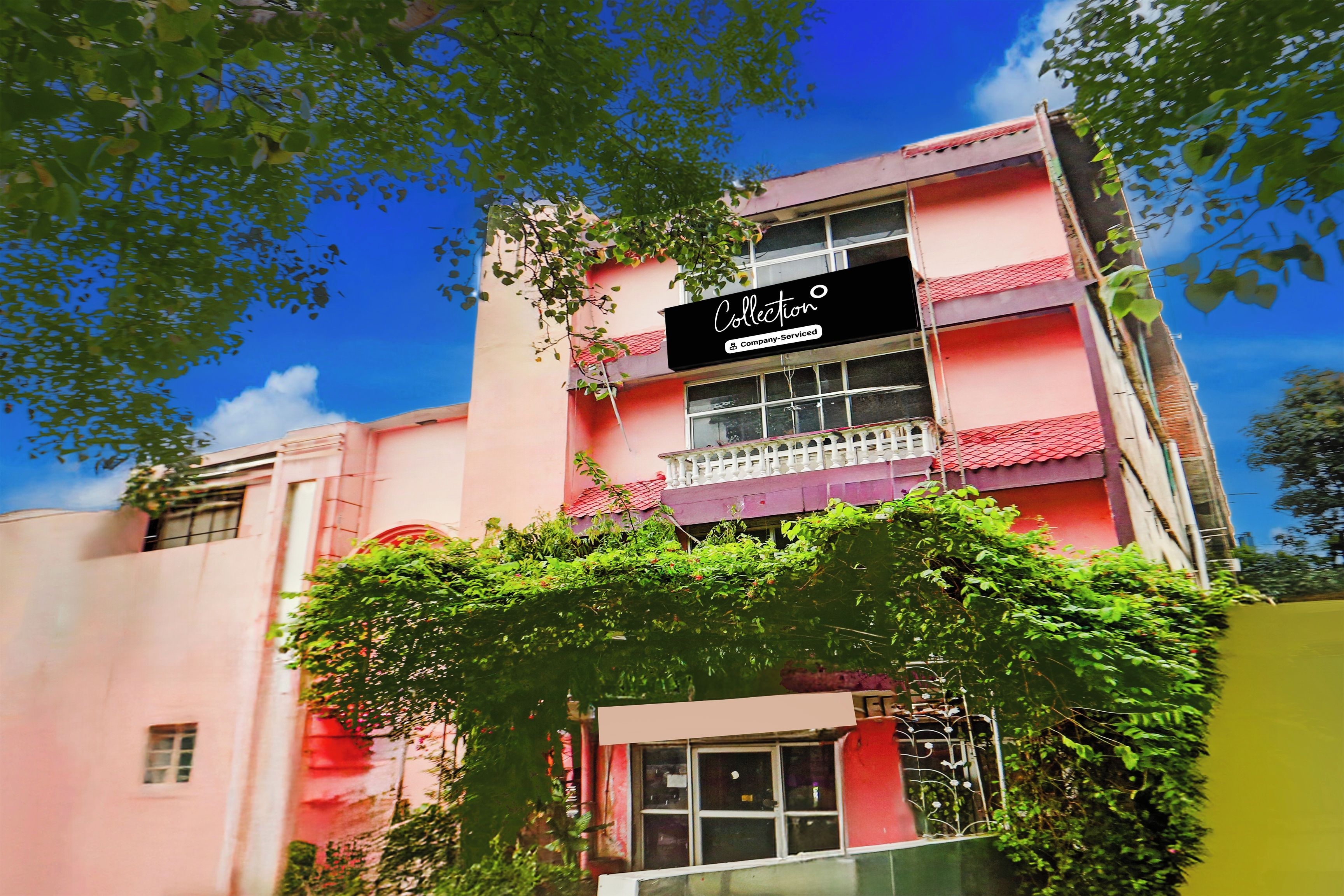 A multi-story building with a sign indicating it is a company-serviced collection.