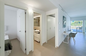 A modern interior with a bathroom, a kitchenette, and a dining area with a view. - Crystalline - Beach and Dream Rentals (Fuengirola)