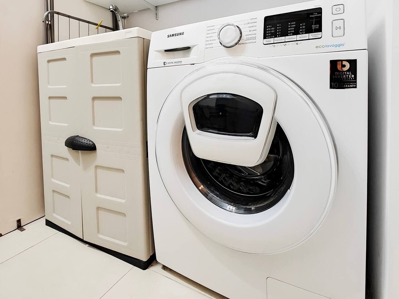 A white Samsung digital inverter washing machine with a control panel and a door with a handle.