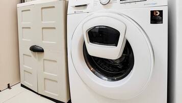A white Samsung digital inverter washing machine with a control panel and a door with a handle.