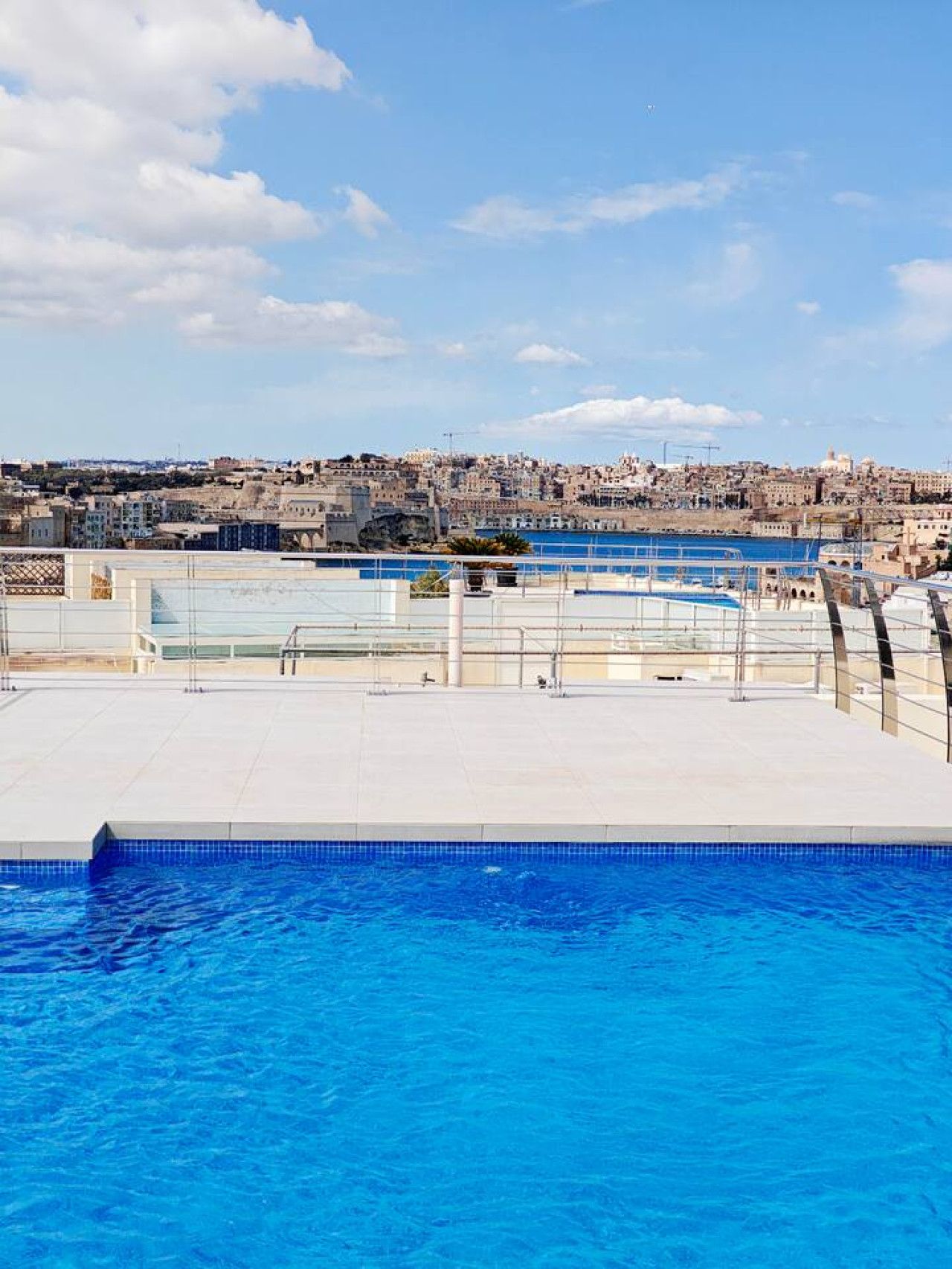 A swimming pool with a view of a cityscape in the background.
