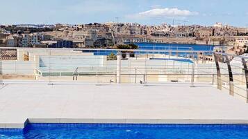 A swimming pool with a view of a cityscape in the background.