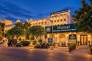 A hotel with a sign for 'Khandwa Haveli' and 'Mumal Multicuisine Restaurant & Hotel'. - Khandwa Haveli – A Boutique Heritage Hotel, Jaipur (Jaipur)
