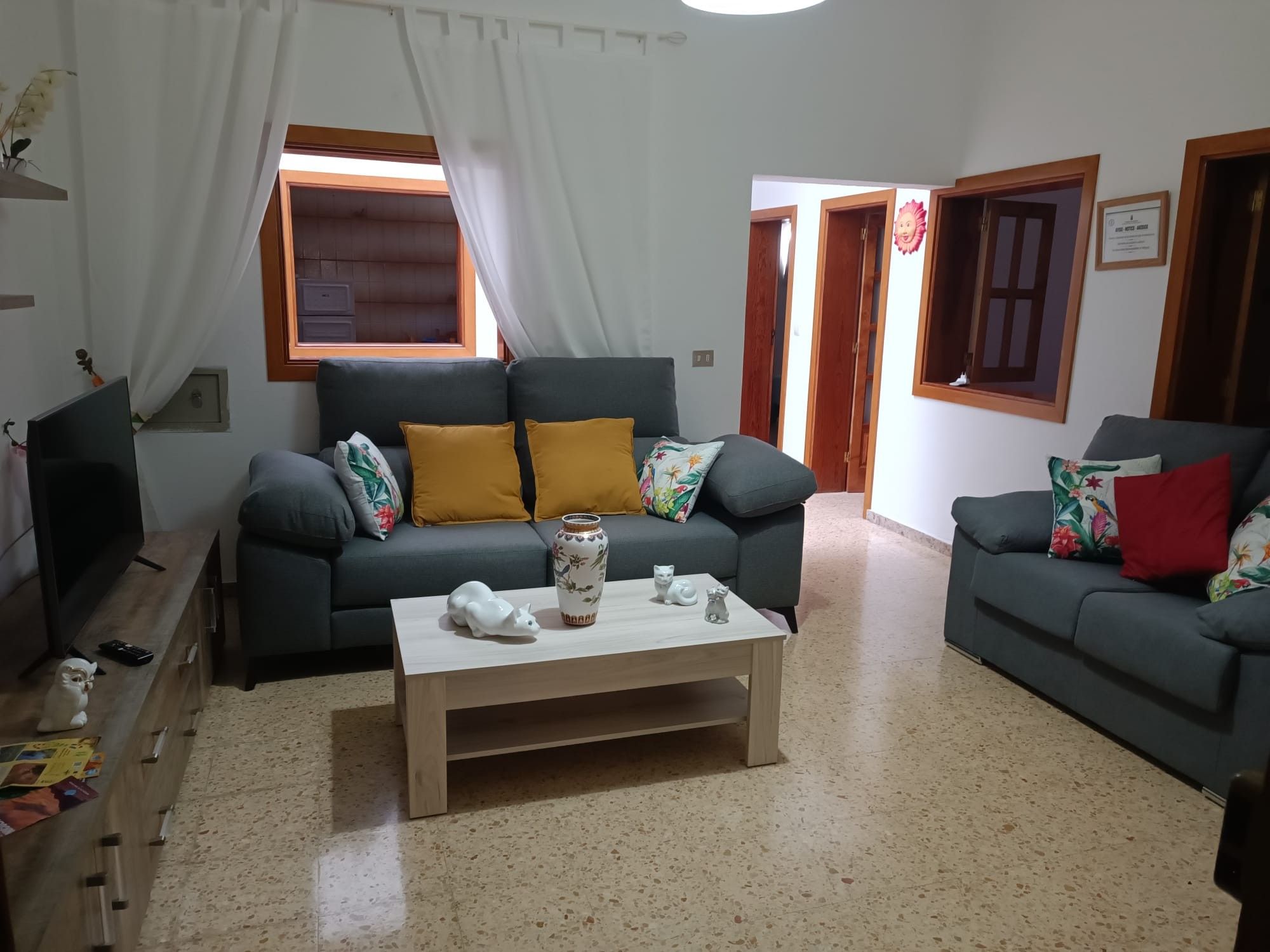 A living room with two sofas, a coffee table, and a TV.