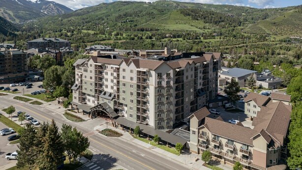 A multi-story hotel with a central courtyard, surrounded by a mountainous landscape. - In the heart of Vail Valley, Sheraton Mountain Vista is the perfect vacation (Avon)